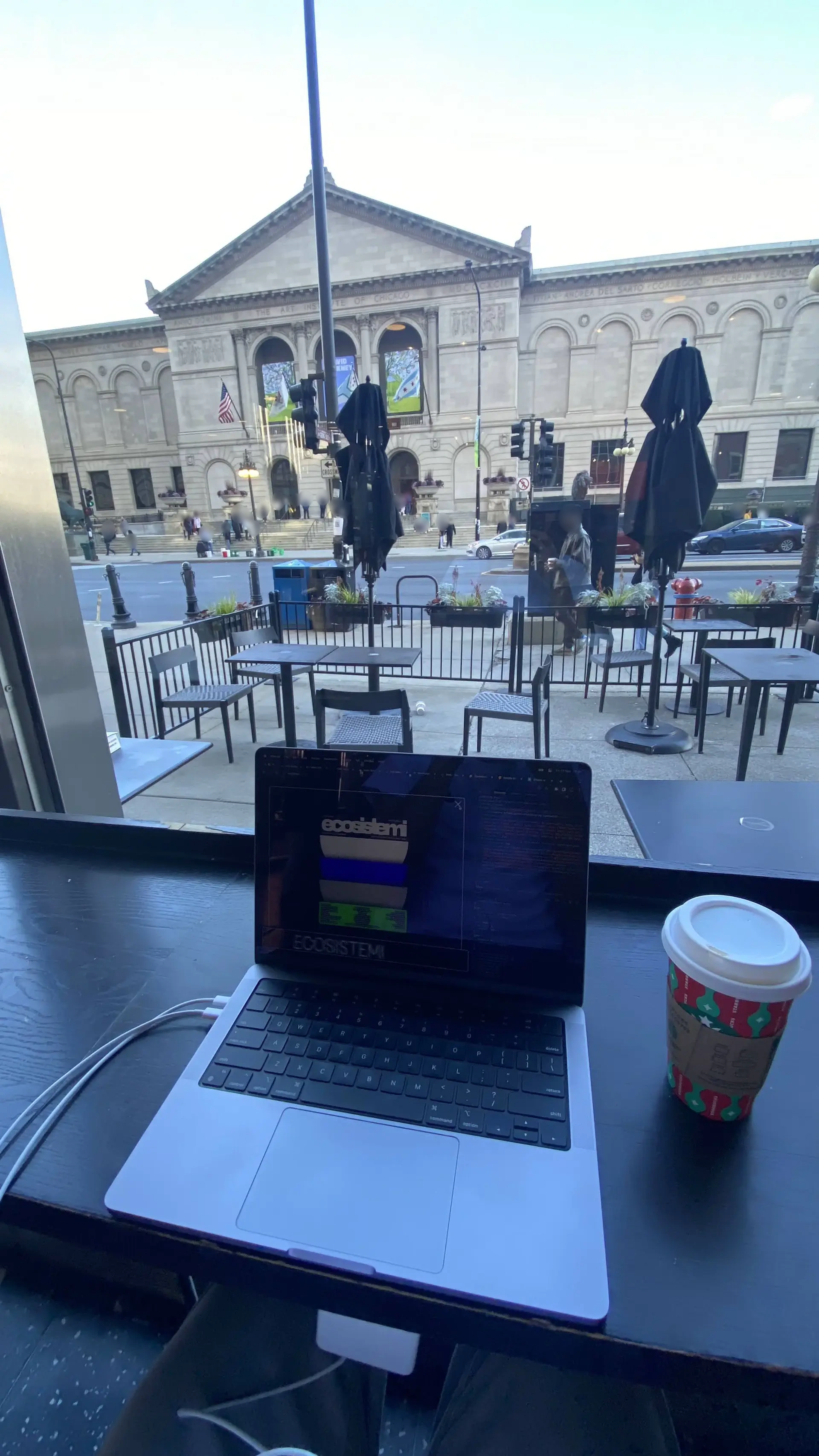 Laptop and coffee at an outdoor café