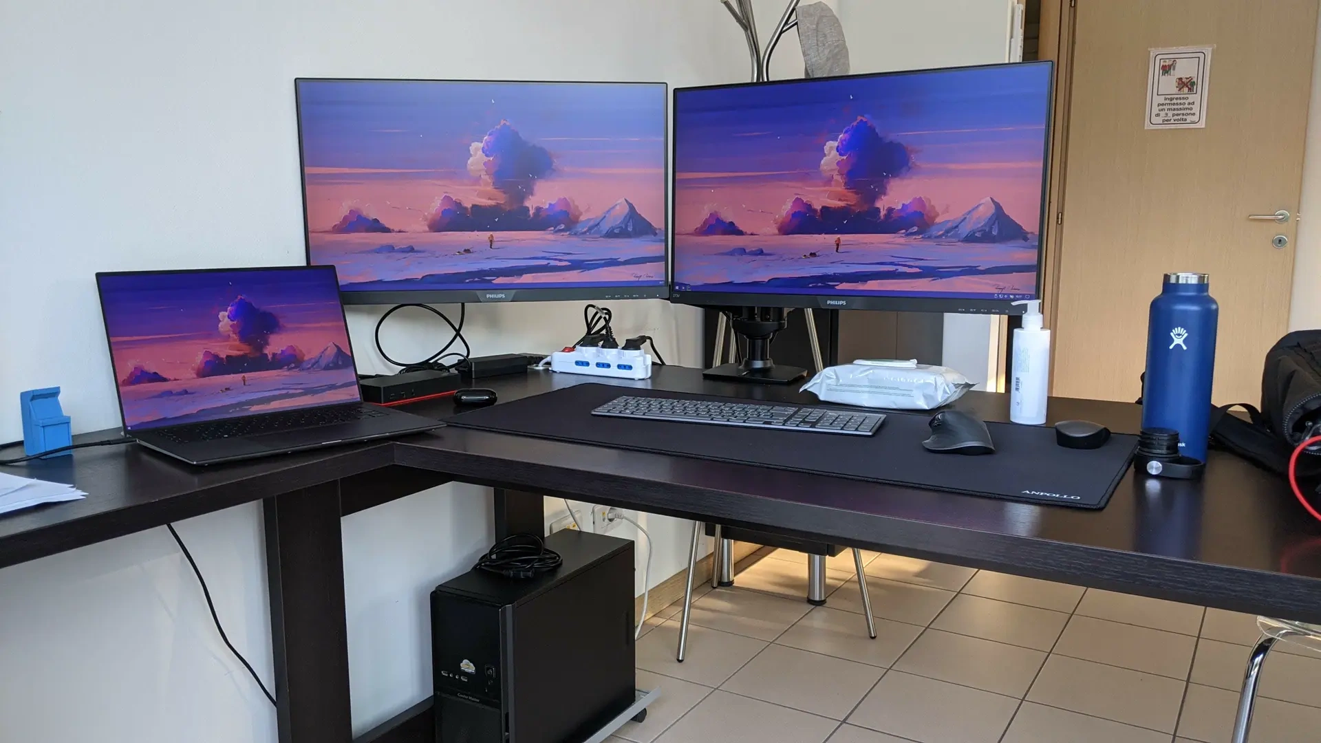 Corner workstation with a laptop and two external displays