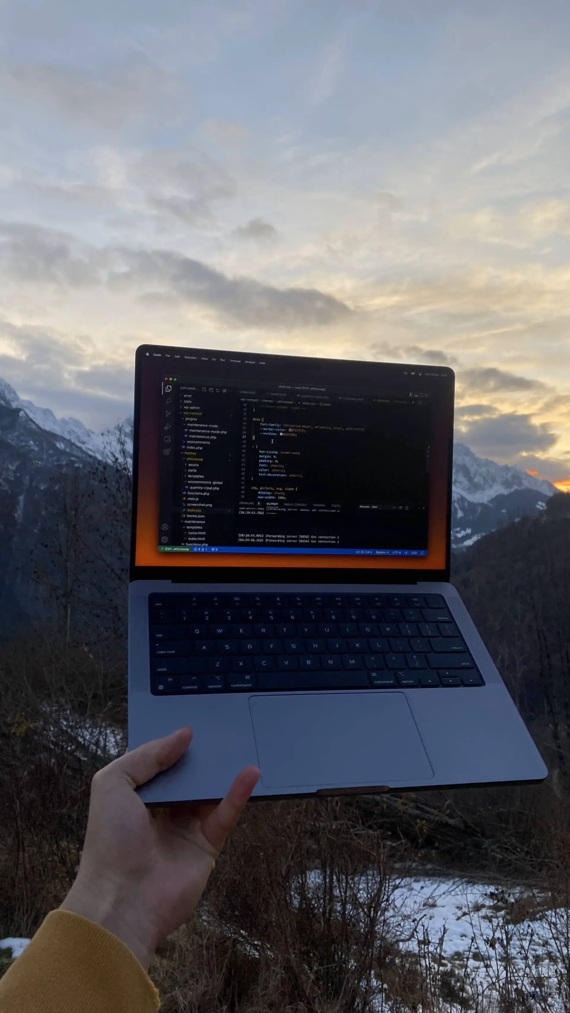 Laptop outdoors with mountains in the background