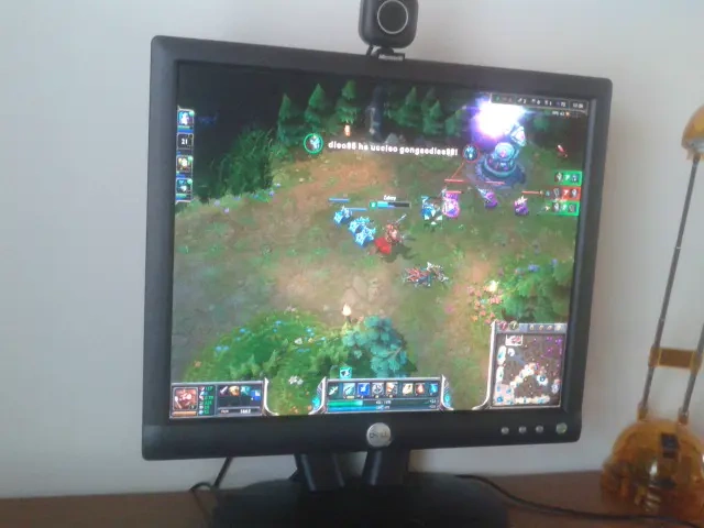 Desktop monitor showing a game with a webcam above it